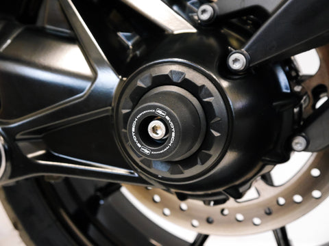The rear spindle bobbin projecting from the nearside rear wheel of the BMW R 1200 RS.