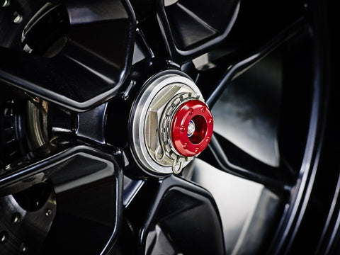 The striking anodised red hub stop from the EP Spindle Bobbins Crash Protection Kit fitted to the offside rear wheel of the Ducati Hypermotard 1100 Evo.