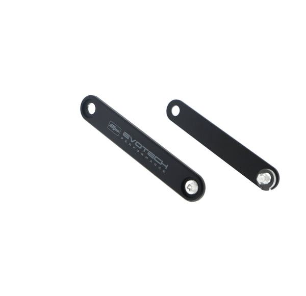 Two black CNC machined aluminium footrest blanking plates with the Evotech logo, intended for use as a pillion footpeg removal kit for the Triumph motorcycle.