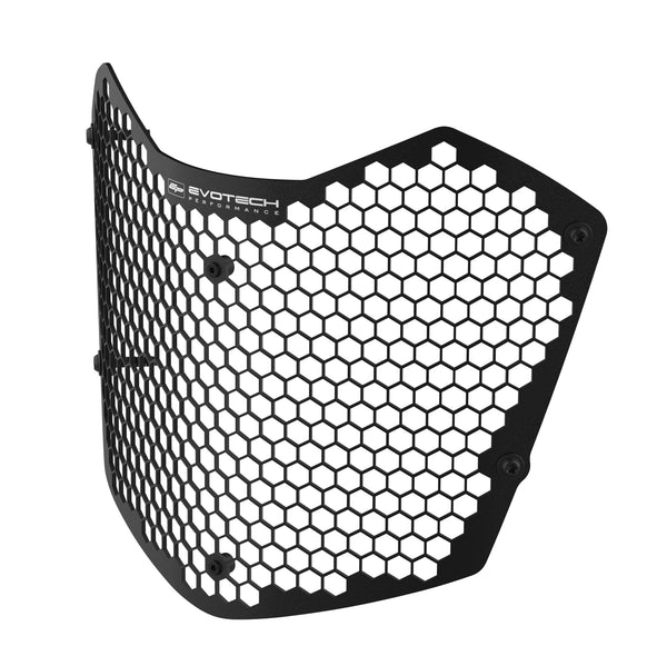 Black Evotech motorcycle headlight shield with a honeycomb pattern mesh and a black fasteners and rubber bungs, shown on a plain white background.