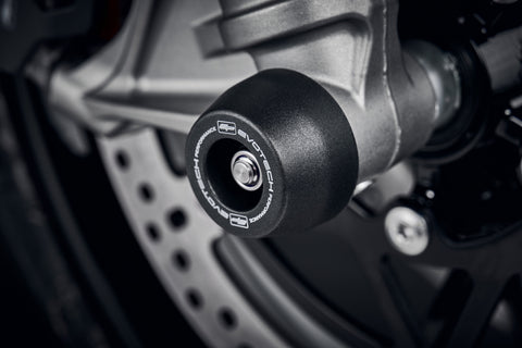 The robust nylon EP Spindle Bobbins Kit attached to the front wheel of the Triumph Speed Triple 1200 RR.