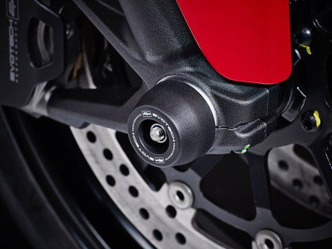 The front wheel of the Ducati Scrambler Desert Sled Fasthouse with EP Front Spindle Bobbins crash protection fitted, one half of the EP Spindle Bobbins Paddock Kit. 